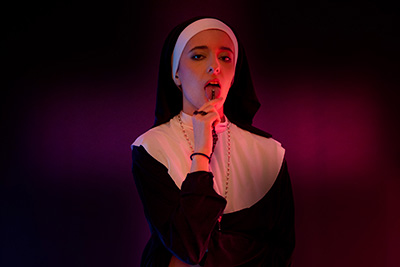Photos of young Molly Saint Rose dressed like a nun and stripping